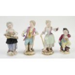 Pair of Dresden figures of a girl and boy holding garden utensils and a bunch of grapes 14cm high,