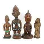 Three Yoruba carved wooden Ibeji figures, two adorned with beads, tallest 33cm high,