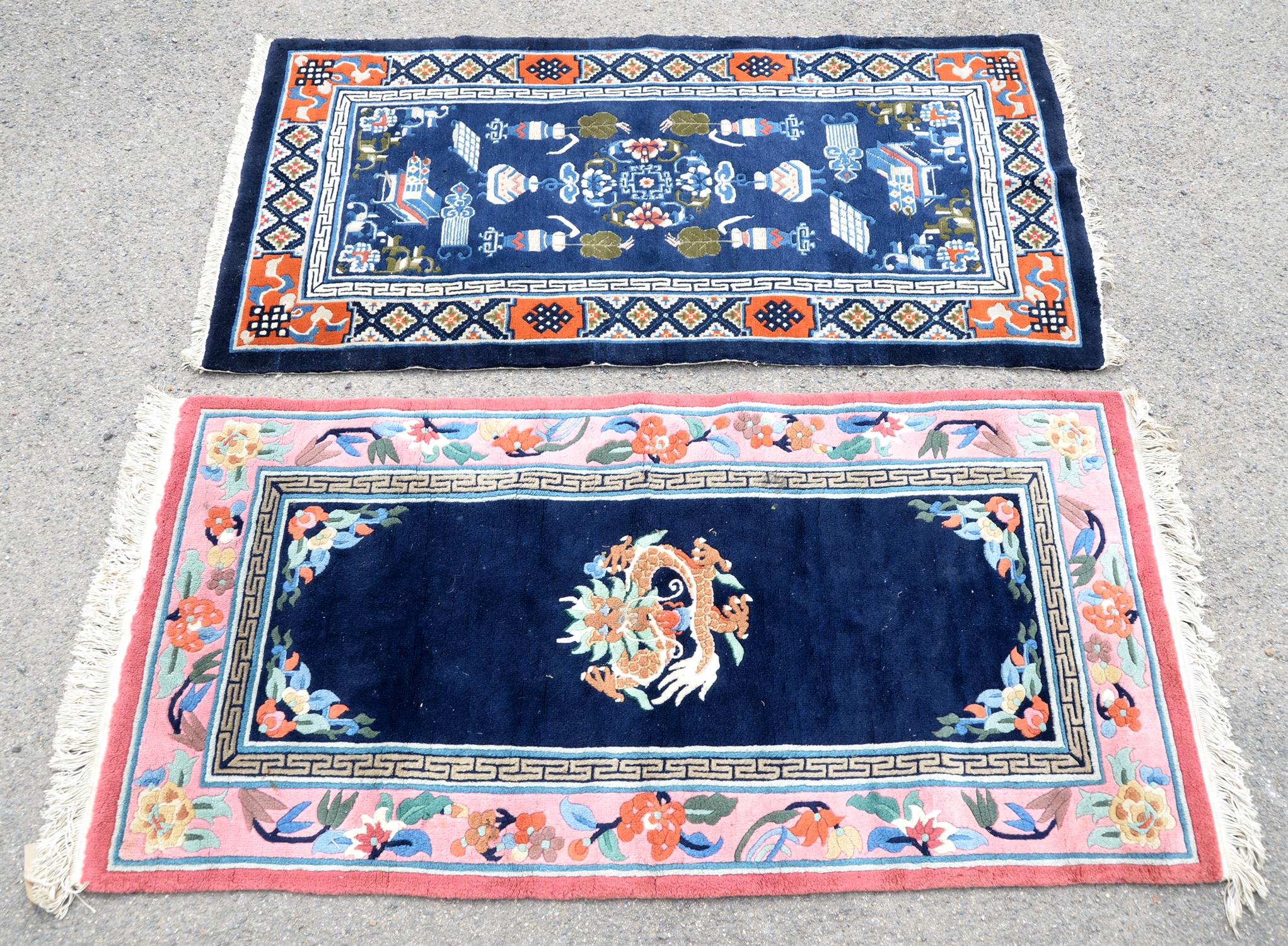 Chinese blue ground rug, central floral medallions and vases and furniture within a Greek key