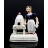 Staffordshire porcelain figural group of a girl holding a watering can or smoker with a beehive,