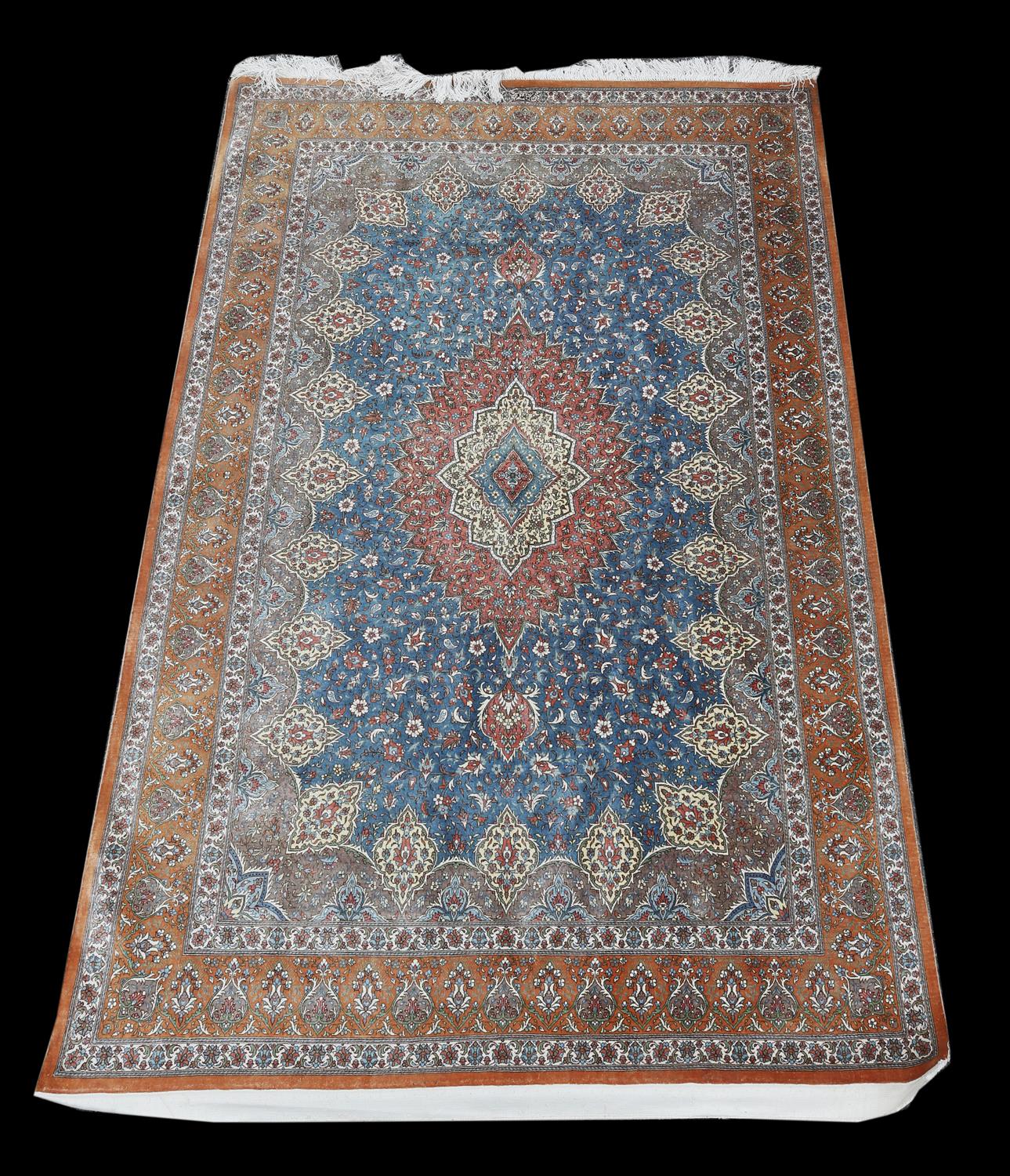 Persian silk rug, with a central floral medallion and floral motifs on a light blue ground,