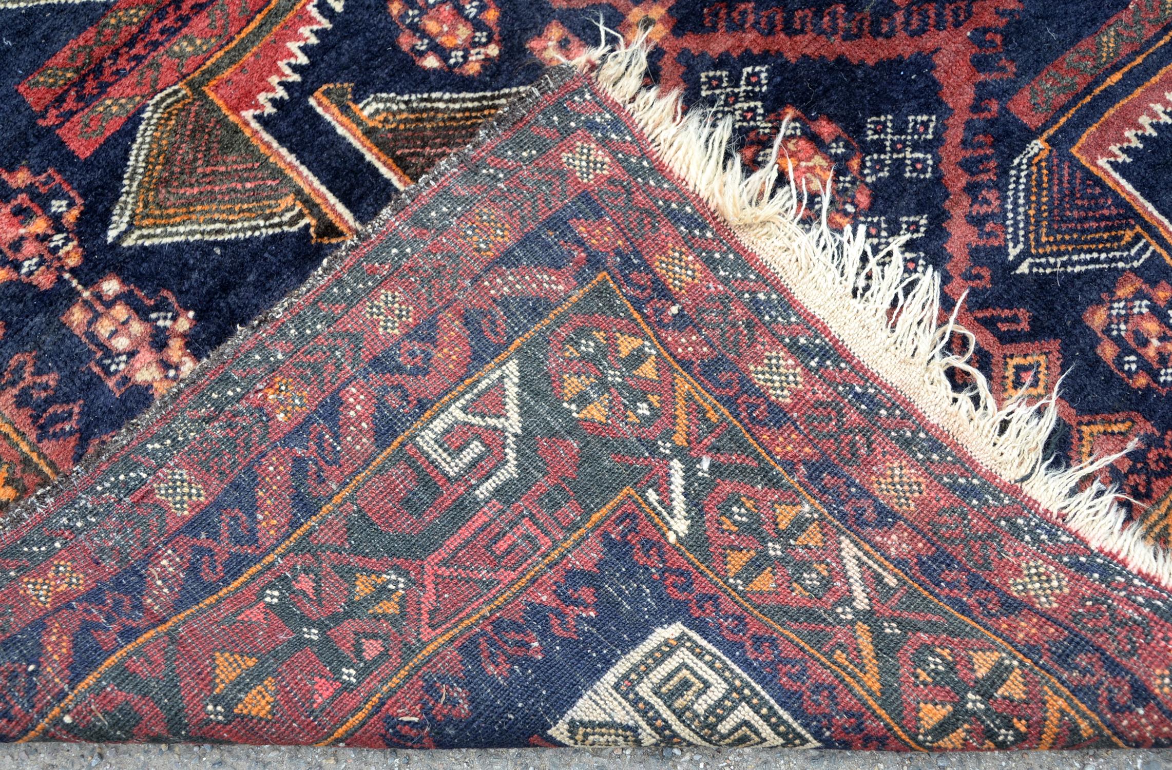 Pakistan rug in the Afghan style, having stylised motifs echoing the war in Afghanistan on a blue - Image 2 of 2