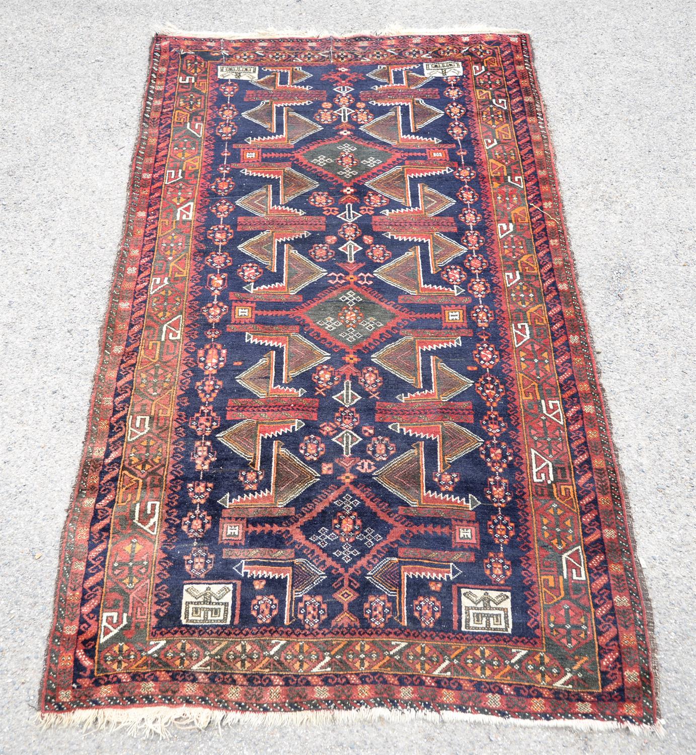 Pakistan rug in the Afghan style, having stylised motifs echoing the war in Afghanistan on a blue