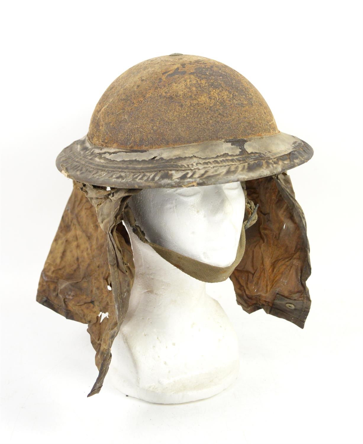 British WWII Brodie Helmet with Havelock, liner and chinstrap in poor condition