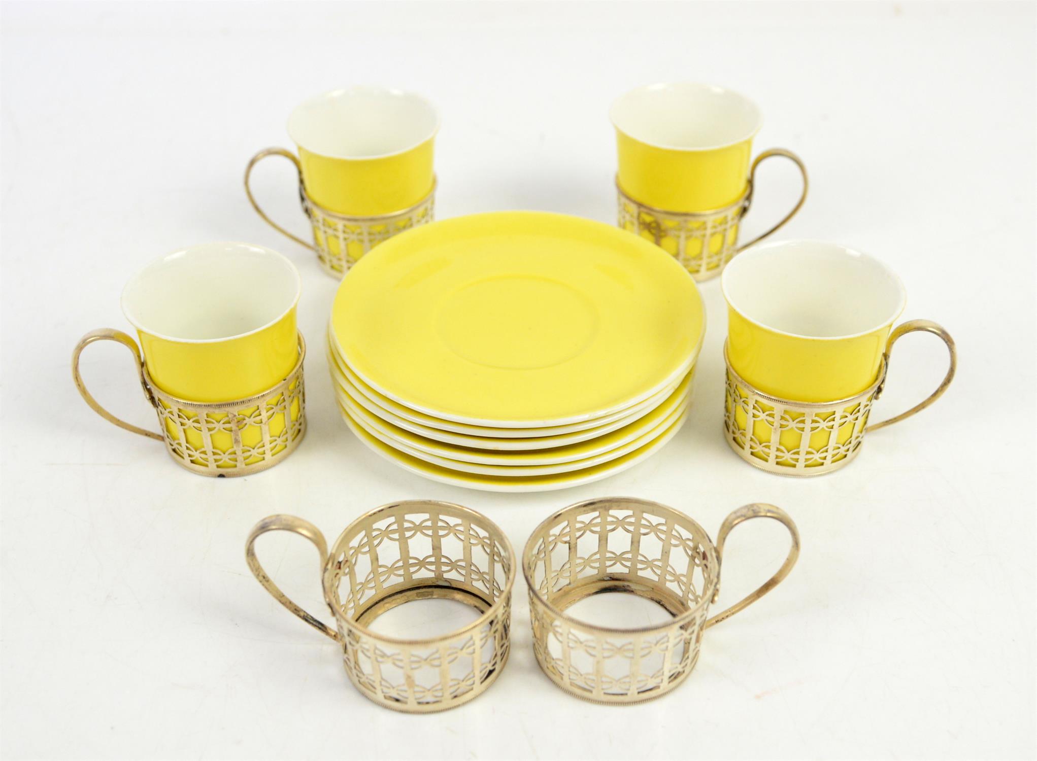Four Shelley China yellow coffee cups and six saucers and six silver cup holders,