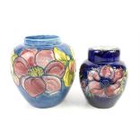 Moorcroft Anemone pattern ginger jar and cover, with pink and purple flowers on a dark blue ground,