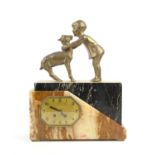 Art Deco clock mounted with figure of a child embracing a fawn, gilt dial, on black and mottled