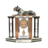 Art Deco marble mantel clock, with spelter lioness above octagonal dial with Arabic numerals,