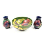 Moorcroft bowl tube line decorated in the Hibiscus pattern on a green ground, impressed marks and