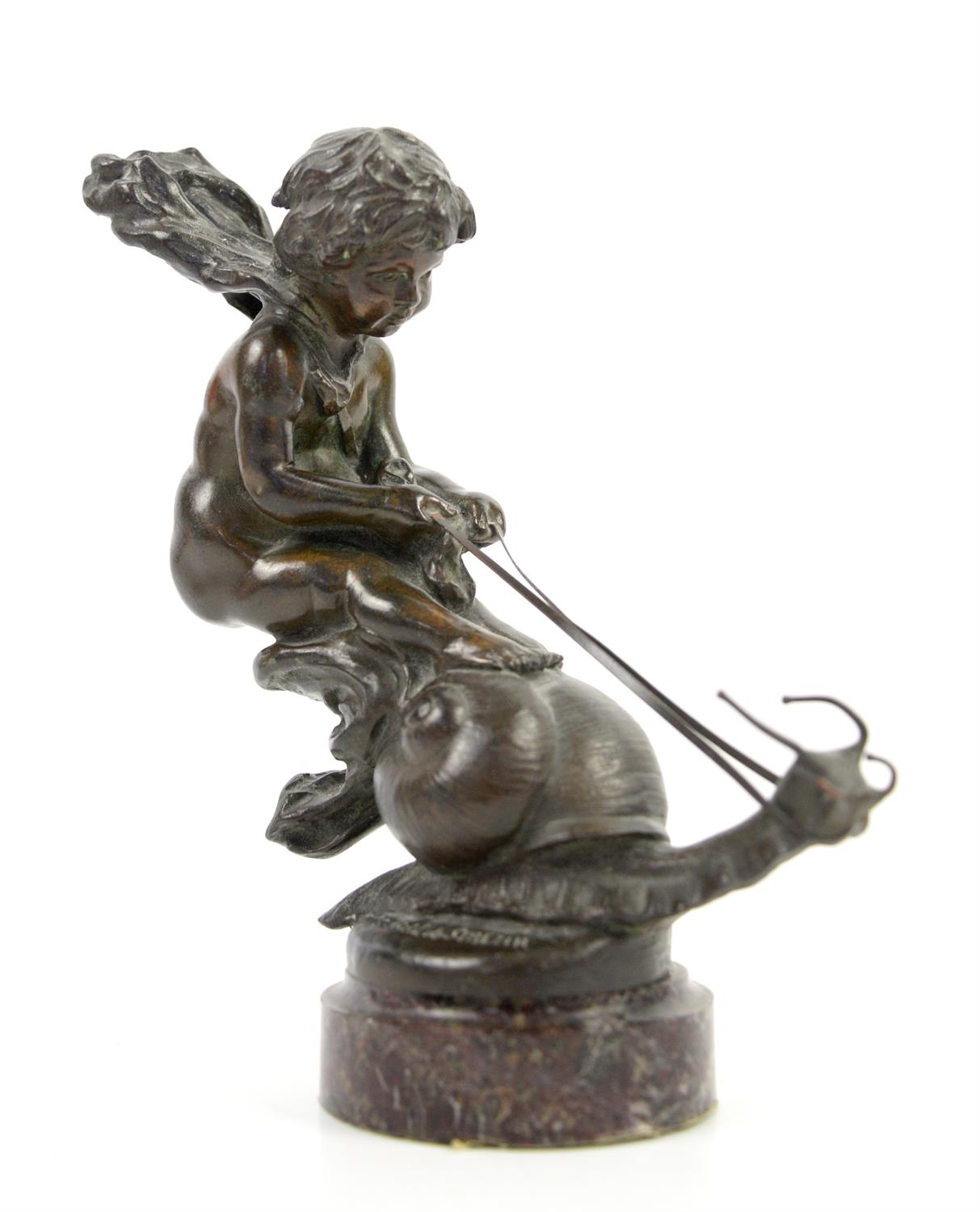 Art Nouveau bronze figure of a young boy or putto riding a snail, inscribed Galral de Serezin, h22.