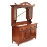 Art Nouveau walnut mirrored back sideboard, the superstructure with two leaded glass cupboard doors