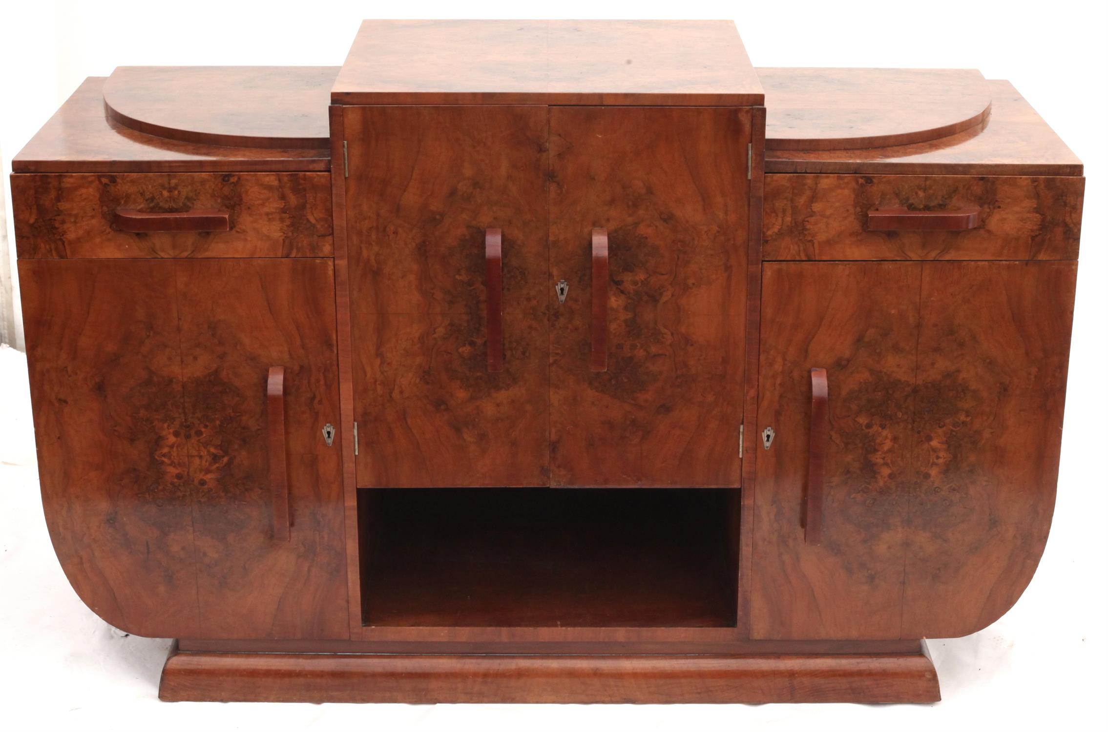 Art Decco burr walnut veneered side board, the central cupboard enclosing three drawers over a