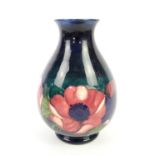 Moorcroft Anemone vase, of ovoid form with flared neck, with pink and purple flowers on a dark