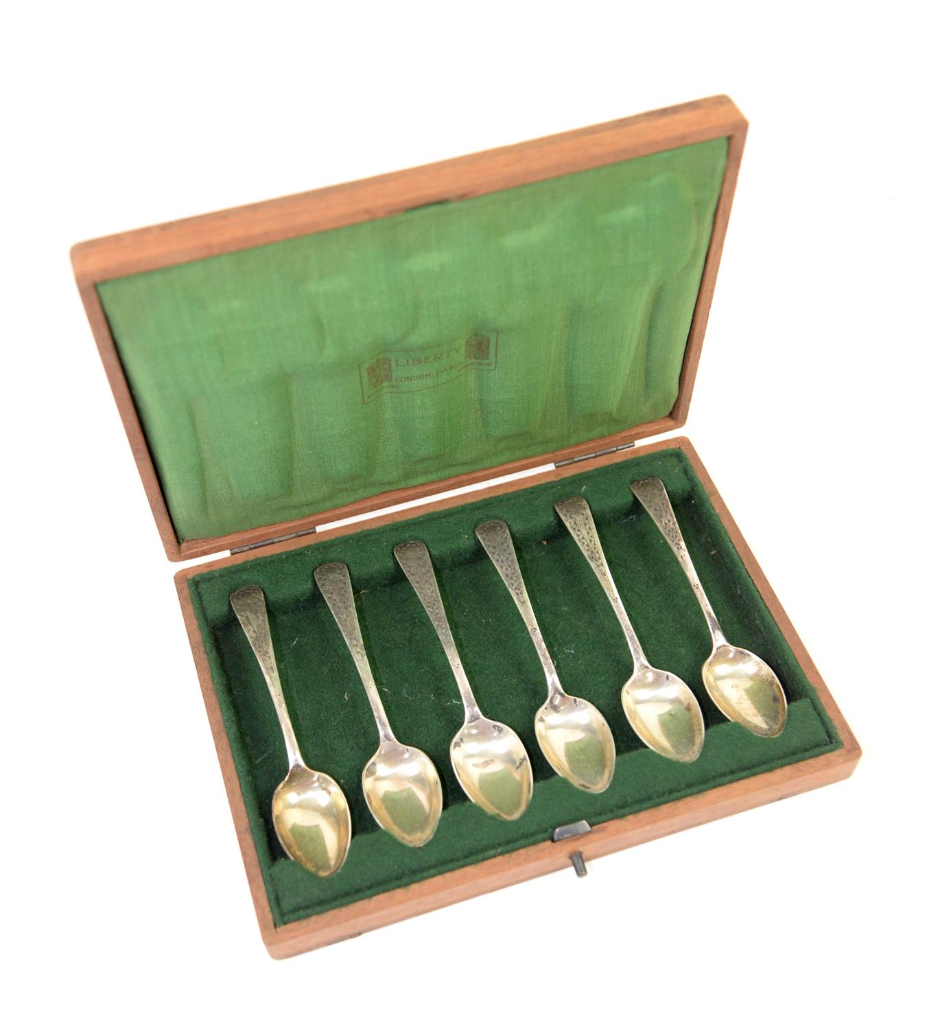 Liberty set of six silver teaspoons, hallmarked, in wooden case lined with green silk which is
