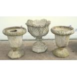 Three reconstituted stone planters, to include one of shell design, h60cm w52cm d51cm,