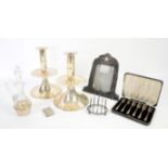 Silver toast rack, forks and picture frame, along with ecclesiastical silver plated candle holders
