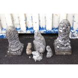 Reconstituted stone items to include two pineapple finials, h53cm and h61cm, three owls,