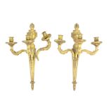 Pair of brass three branch wall sconces with flame finials, 48cm high,