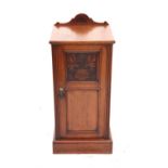 Late Victorian walnut bedside cupboard with carved panelled door on plinth base, h87 x w38 x d36cm,