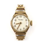 Rotary, A ladies gold oval cased wristwatch, the signed white dial with gold Arabic numeral hour