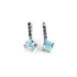 Pair of topaz and tanzanite earrings, square step cut blue topaz, suspended from a tanzanite set