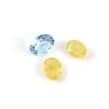 Three loose gemstones including, two oval yellow sapphires with estimated weights 2.36 carats and 2.