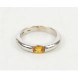 Synthetic yellow sapphire ring, set with an oval synthetic yellow sapphire measuring an estimated 6.