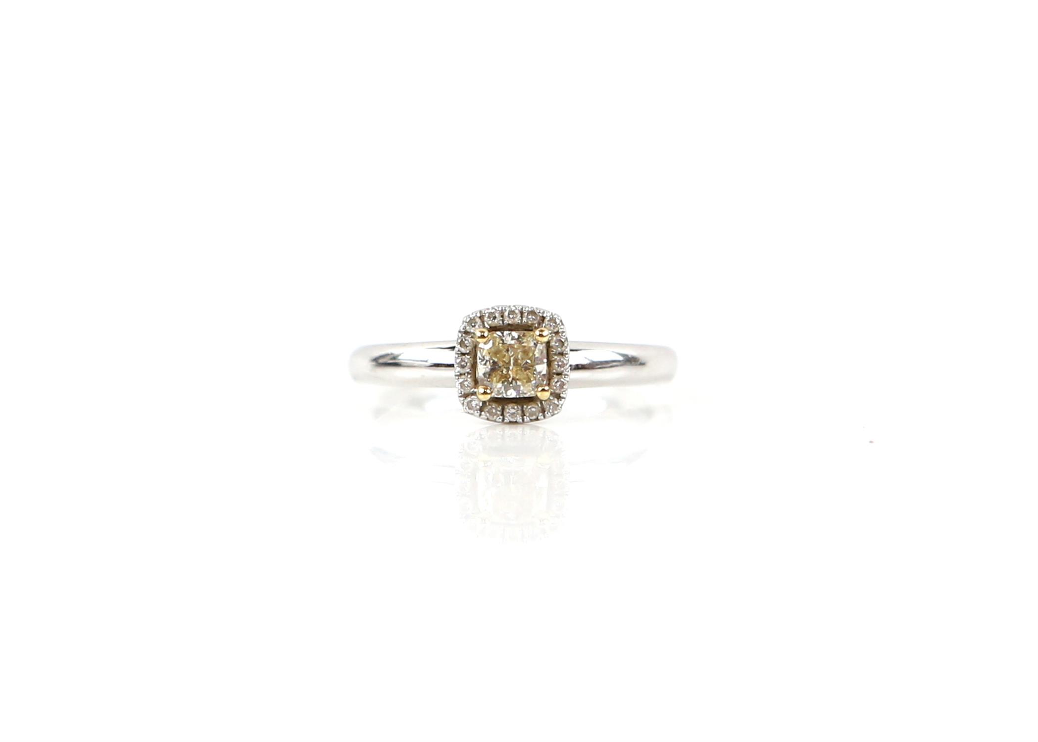 Contemporary diamond cluster ring, set with central square cushion cut yellow diamond,