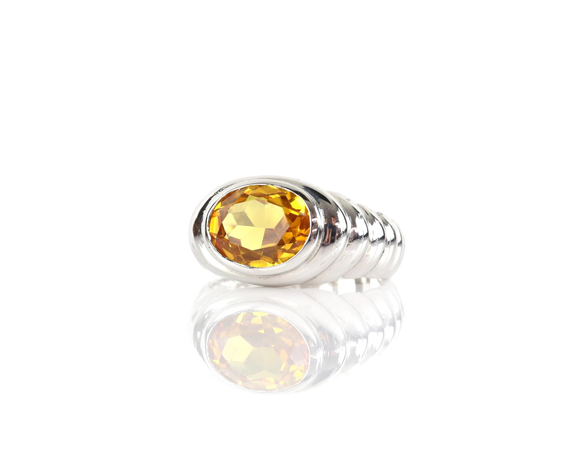 Modern synthetic yellow sapphire ring, set with an oval cut yellow synthetic sapphire,