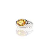 Modern synthetic yellow sapphire ring, set with an oval cut yellow synthetic sapphire,