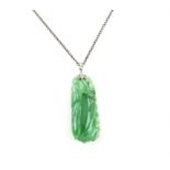 Jade pendant depicting a plum and vines, with a platinum bale set with three diamonds on a silver