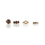 Four gem set rings, including a garnet cluster ring, size N, a three stone garnet ring, size M,