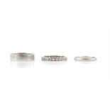 Three rings, including a full eternity ring, set with round brilliant cut diamonds,