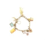 Vintage gold charm bracelet, curb link with heart padlock clasp and safety chain,