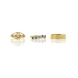 Three gold rings, including a sapphire and diamond cross over ring, ring size O, a diamond five