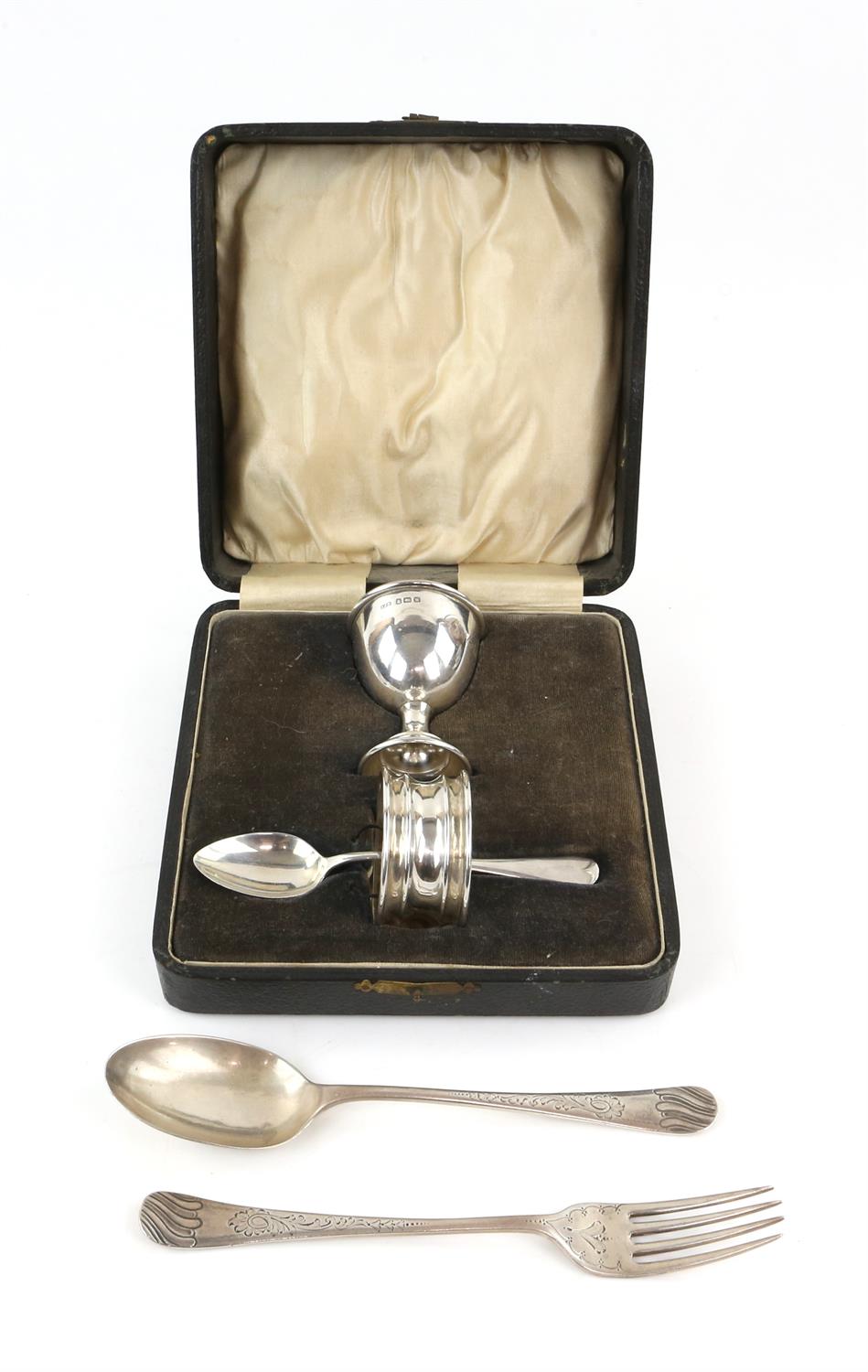 Three piece silver christening set to include egg cup, spoon and napkin ring in case,