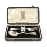 George V three piece silver christening set comprising: fork, spoon and napkin ring, cased,