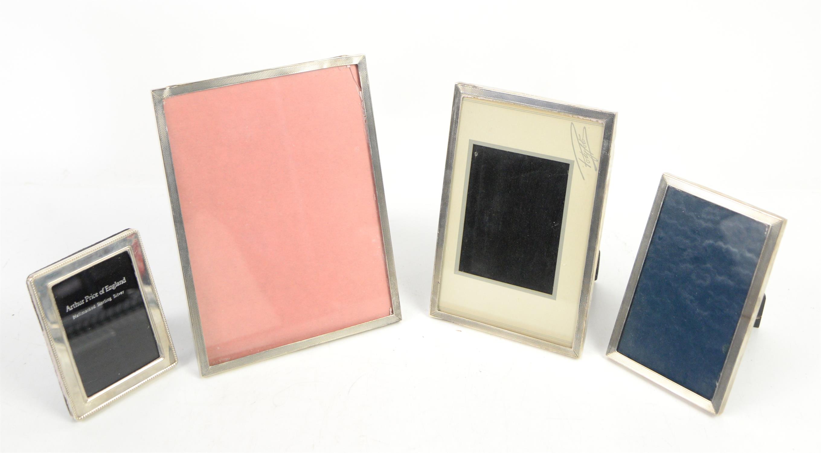 Three matched graduated silver photograph frames with engine turned decoration, by Sanders &
