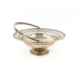Silver bon bon dish, of pierced circular form with swing handle, on spreading base, Barker Brothers,