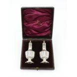 Cased pair of demi fluted silver peppers by John Millward Banks, Birmingham 1901