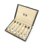 A set of six silver coffee spoons by Liberty & Co with semi precious stone “bean” terminals,