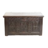 18th century oak coffer, the three panelled front with floral carving, on square supports,