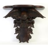 Mahogany wall bracket with eagle on a perch amongst fruiting branches, h64cm