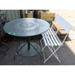 Green cast metal garden table, the circular top with pierced decoration on scrolling supports,