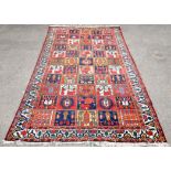 Antique Afghan rug with repeating medallions within geometric borders, 222 x 140cm