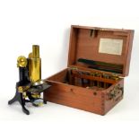 Lacquered brass microscope by J. Swift & Son, London, with rotating triple nose piece,