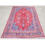 Persian Kashmar pink/red ground carpet, with floral design within floral borders, 303 x 193cm