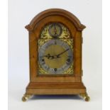 Early 20th century walnut cased bracket clock, the arched dial with silvered chapter ring with