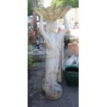 Reconstituted stone bird bath with Classical youth holding a bowl with scalloped edges, on base,