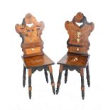 Two 19th century Continental marquetry and bone inlaid hall chairs one with Putti amongst